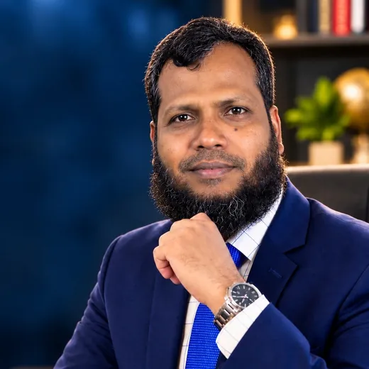 Engr. Sayfullah in a navy suit, hand under chin